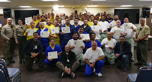 group picture of inmates, corrections officers and chaplain in Finding the Way program