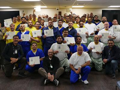 group picture of inmates, corrections officers and chaplain in Finding the Way program